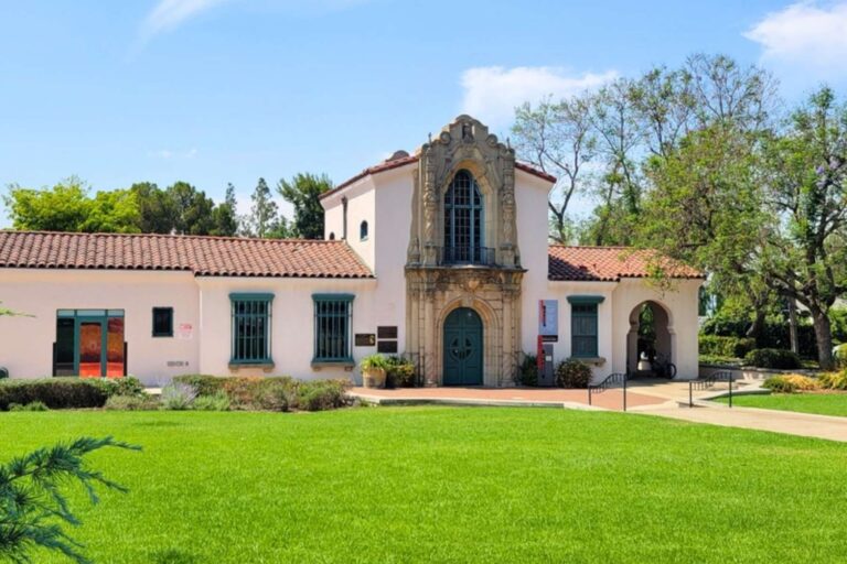 Large Spanish-style light building on a sunny day