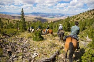 Horseback riding during a family dude ranch vacation.