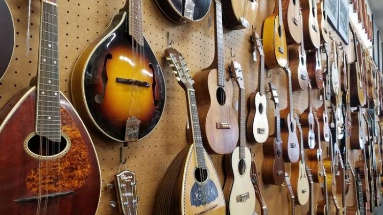 An ample wall of various guitars