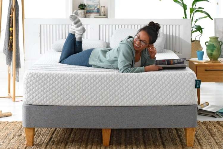 Woman laying on a Leesa Hybrid bed