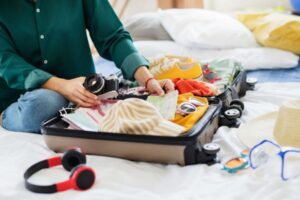 A person packing a suitcase.