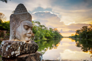 Stone face Asura on causeway near South Gate of Angkor Thom in Siem Reap, Cambodia. Photo by iStock