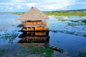 A hut protrudes above the water in Iquitos, Peru. Photo by Tony Mangia