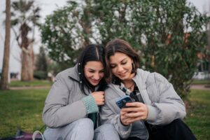 Two women looking at a phont. Photo by Yunus TuğYunus Tuğ, Unsplash