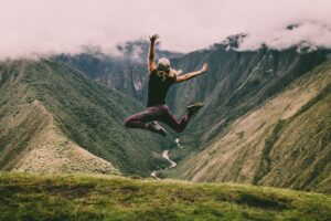 Woman jumping in Peru. Photo by Peter Conlan, Unsplash