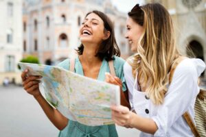 Women looking at map. Photo by Unsplash + in collaboration with Getty Images